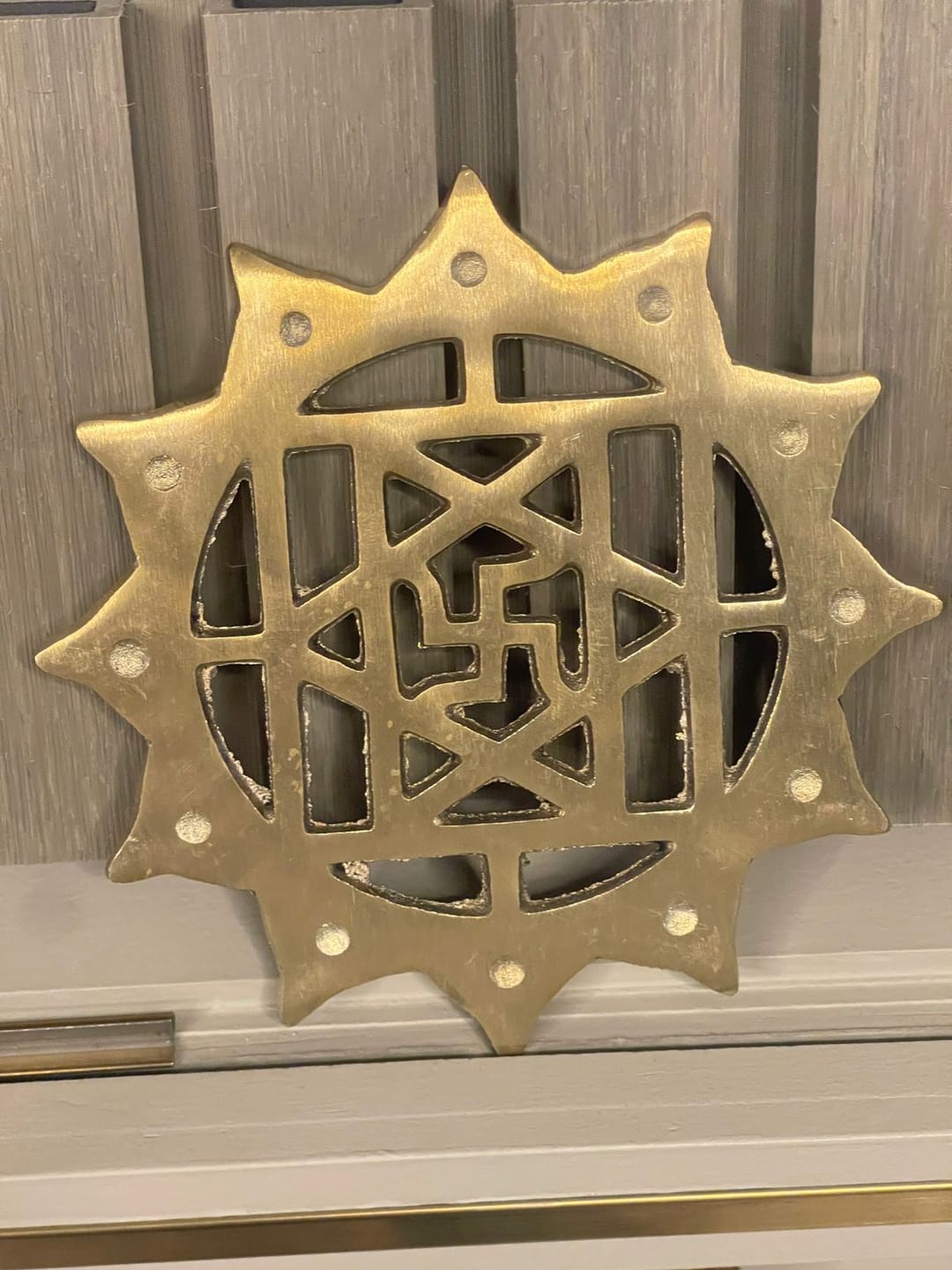 Customer photo review of Brass Swastik with Lotus Helix – Vastu Remedy for Main Door Protection | Evil Eye & Positive Energy Shield | Kitchen/Entrance Placement | 6 x 6 Inch