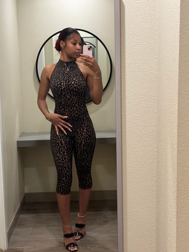 Reviewer taking a mirror selfie in the burnout print halter capri jumpsuit, showing the full-length bodycon fit.