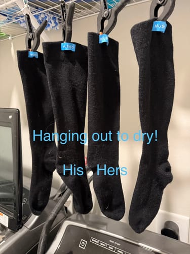 Customer's two pairs of black Performance Eucalyptus Compression Socks hanging on clips to dry.
