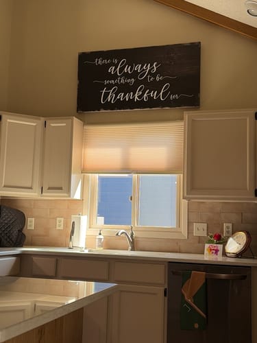 Reviewer's 'Always Something To Be Thankful' sign hanging on the wall in their kitchen above a window.