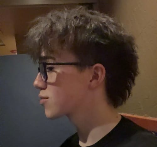 Reviewer in profile showing voluminous, textured hair styled with Texture Powder.