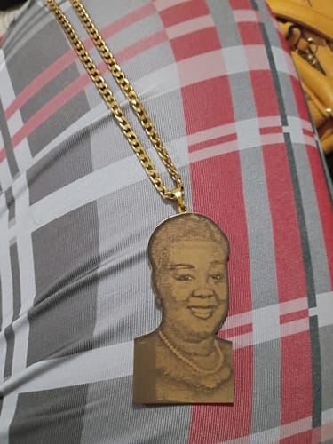 Customer's gold Custom Photo Engraved Pendant Necklace with a thick chain, showing a detailed engraving of a woman.