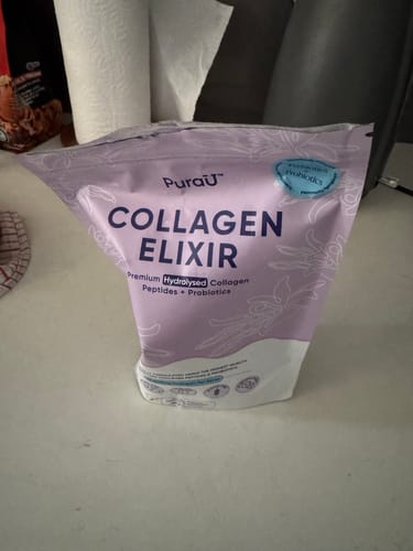 Customer's purple and white pouch of PuraU Collagen Elixir sitting on a countertop.