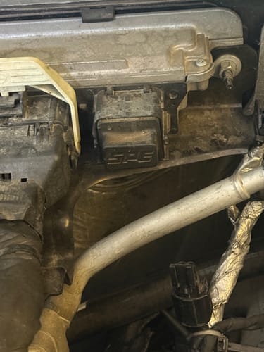 Close-up of a customer's SPE Motorsport Emissions Harness Plug installed on a truck's ECU.