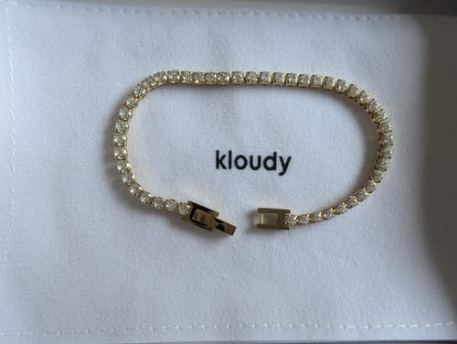 Customer's sparkling Diamond Tennis Bracelet unclasped and displayed in its packaging.