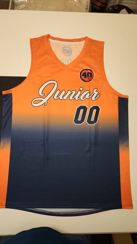 Customer's custom basketball jersey laid flat. It has an orange to navy gradient with 'Junior' and '00' on the front.