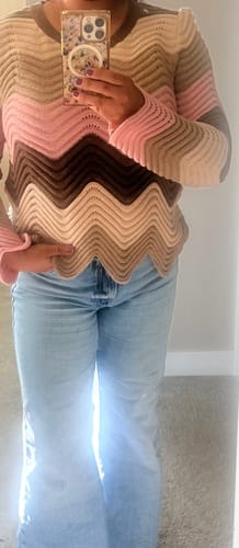 Reviewer wearing the Abigail Wave Color Block Sweater, showing its wavy pattern and scalloped hem with jeans.