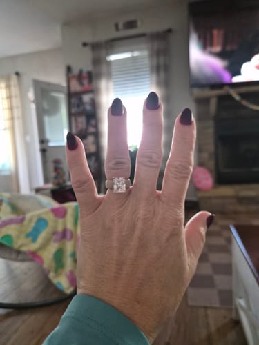 Customer's hand wearing the Silicone Ring, showcasing the large emerald-cut stone.