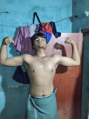 Reviewer flexing their biceps to show their physique after using Wellcore Creatine Monohydrate.