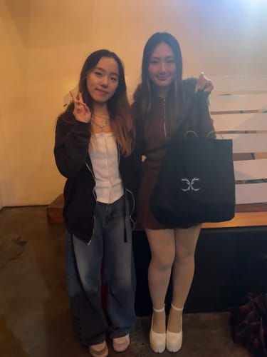 Reviewer wearing the brown Fur Trim Mocha Cable Knit Set, showing the zip-up hoodie and skirt while posing with a friend.