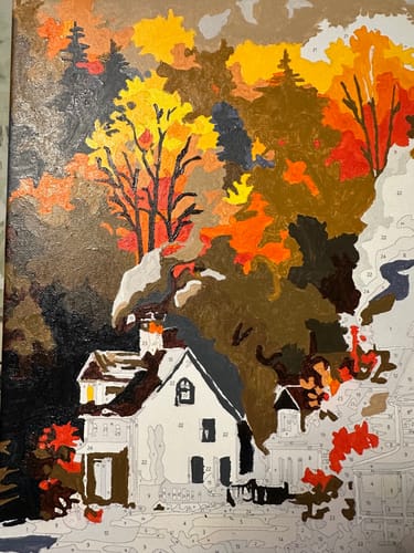 Close-up of a customer's 'Village in Autumn' paint by number, showing the colorful top half completed and the bottom unpainted.