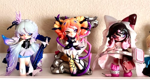 Customer's three different NONO SOVA Nightmare Lullaby figures on a shelf, highlighting the reviewer's favorite in the middle.