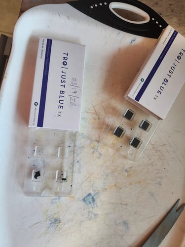 Customer's photo of Just Blue, showing the dark troches in a blister pack next to an empty one.