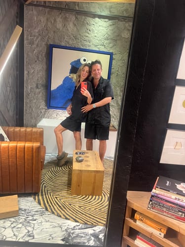Reviewer and their partner posing in matching black Dachshund Delight Silk Short Sets for a mirror selfie.