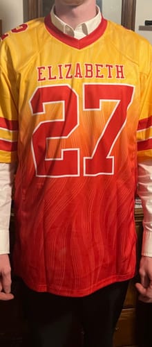Customer modeling the front of a custom gold red gradient football jersey with the name ELIZABETH and number 27.