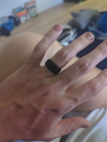 Customer's hand wearing the black Men's Infinity Silicone Ring.