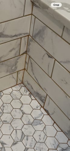 Customer's close-up of a shower corner with discolored, stained grout before cleaning with the Shower Starter Bundle.