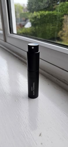 Reviewer's sleek black Travel Atomiser standing upright on a white windowsill.