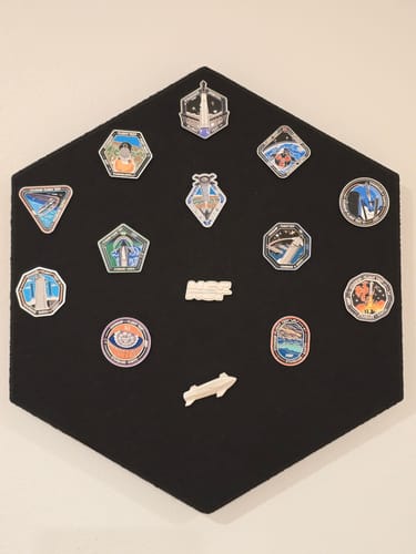 Customer's Starship Flight Pin Collection arranged on the hexagonal black felt display mount.