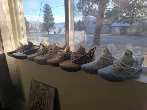 Reviewer's collection of Joker basketball shoes, including the new Joker 2 'Denver', displayed on a windowsill.