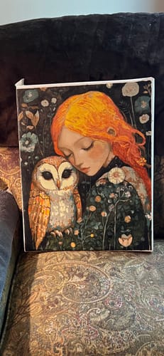 Customer's finished 'The Watchful Perch' painting of an orange-haired girl with an owl, displayed on a patterned couch.