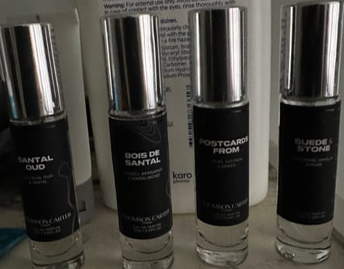Customer's Bois De Santal Eau de Parfum bottle shown with three other fragrances from the same collection.