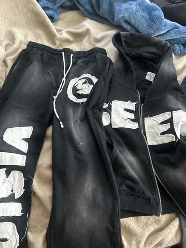 Customer's black SEEK VISIONZ SET laid out, showing the distressed lettering on the hoodie and pants.