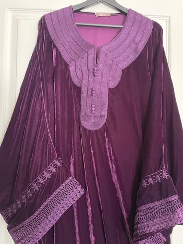Reviewer's Jumanah jellaba in purple velvet, showing the detailed embroidery on the collar and cuffs.