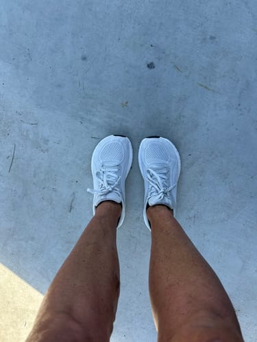 Reviewer standing in white MUUV Flow pickleball shoes, showing the wide toe box shape from a top-down view.