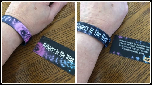 Customer shows two views of the Whispers In The Wind Bracelet on their wrist: the dandelion design and the interior text.