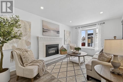 Customer's 'Golden Hour on Lake Ontario' canvas hanging above a white fireplace in a bright, modern living room.