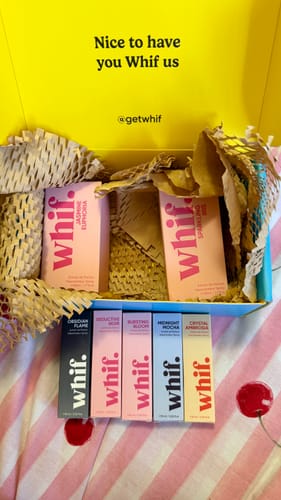 Customer's black Obsidian Flame perfume box displayed with other colorful whif fragrances in front of their shipping box.