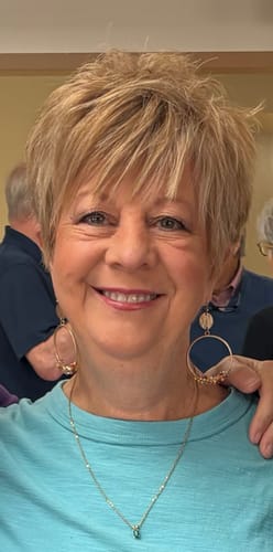 Customer smiling and showing the results of using My Amazing Lashes Mascara on her long lashes.