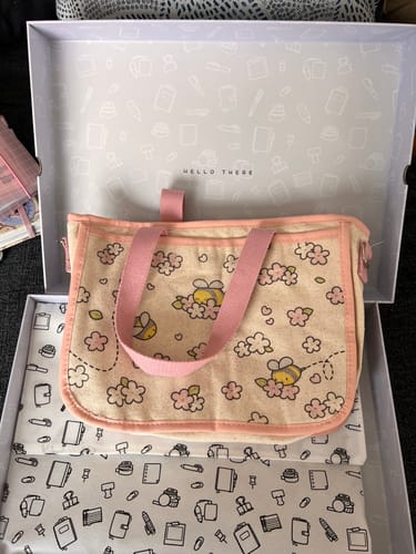 Customer's Bees & Blossoms Journal Buddy with pink straps, sitting inside its original decorative box.