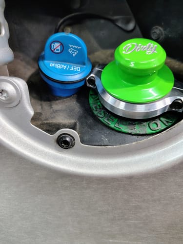 Customer's photo showing the green RAM Billet Fuel Cap installed with a snug fit next to the blue DEF cap.