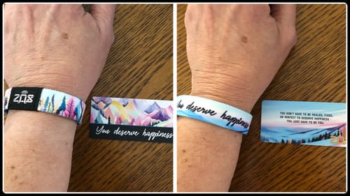 Reviewer showing both sides of the 'You Deserve Happiness Bracelet' on their wrist in a side-by-side photo.