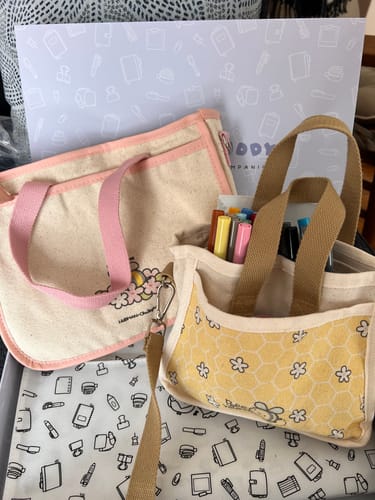 Customer's Bees & Blossoms Journal Buddy shown next to a smaller yellow journal bag for size comparison.