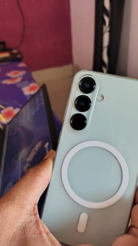 Customer holding a smartphone, showing the smooth back surface where the StickyPod mount attaches.