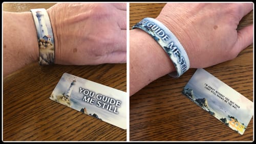 Customer's collage showing the "You Guide Me Still Bracelet" on wrist, displaying the outer lighthouse art and inner engraved title.