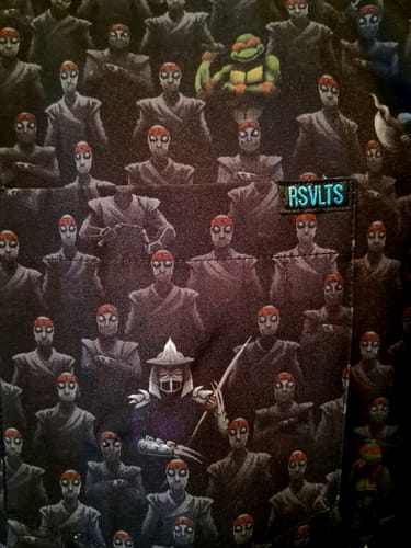 Customer's close-up of the 'Fear the Foot' shirt, showing the detailed pattern of the Foot Clan, Shredder, and a Turtle.