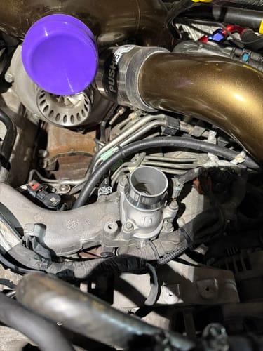 Reviewer's SPE High Flow Thermostat shown installed in a 6.7L Powerstroke engine bay.