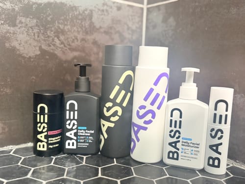 Reviewer's Daily Skincare Duo alongside the matching shampoo, conditioner, and deodorant on a bathroom shelf.