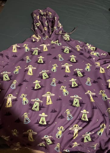 Customer's purple Scream Me Up! Performance Hoodie laid flat, showing the detailed alien abduction pattern.