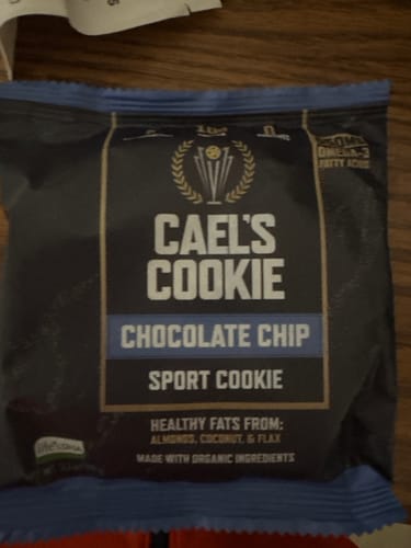 Customer's Cael's Cookie Chocolate Chip sport cookie in its dark, rectangular packaging.