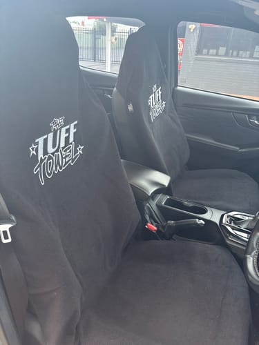 Customer's two black Tuff Towel seat covers fitted neatly on the front seats of their car.