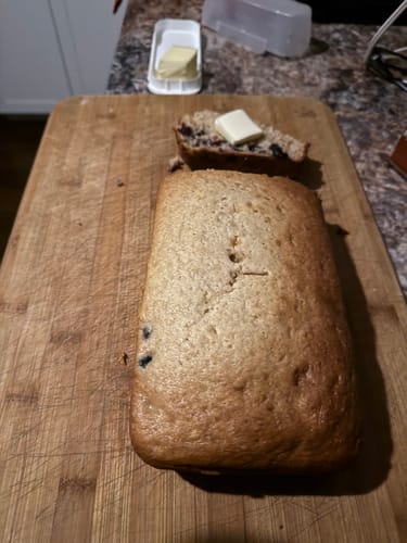 Customer image of a loaf of bread on a wooden cutting board.