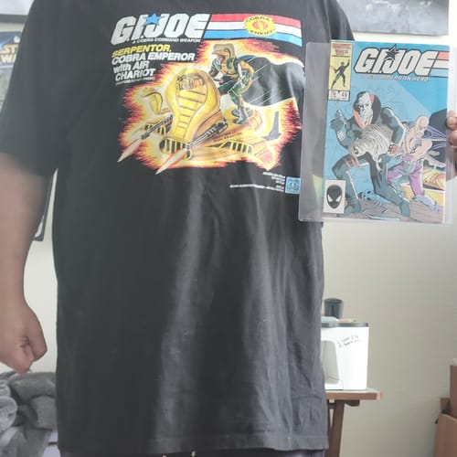 Reviewer wearing the Serpentor Air Chariot t-shirt while holding up a related GI Joe comic book.