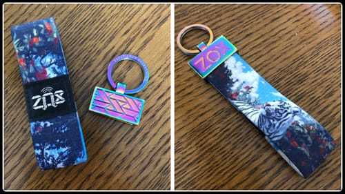 Customer shows the multicolor ZOXLOX Keychain before and after attaching it to a fabric strap with a tiger design.