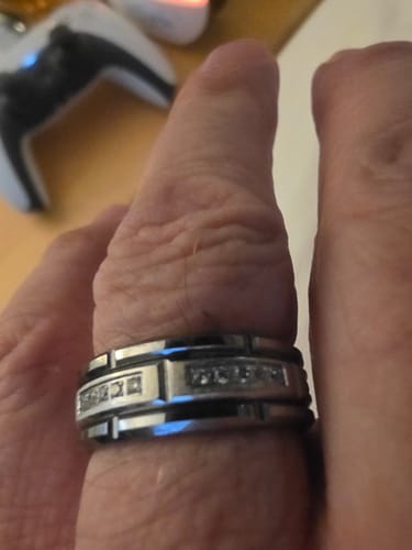 Close-up of a customer wearing the Kaelen Ring, showing its comfortable fit and detailed zircon inlays.