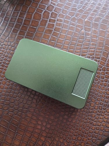 Customer's green Mission Case resting on a textured brown surface.
